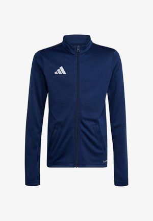 Granatowa kurtka zapinana na zamek, wykonana z miękkiego materiału, z kołnierzem stojącym, dwiema bocznymi kieszeniami i białym logo na lewej piersi.