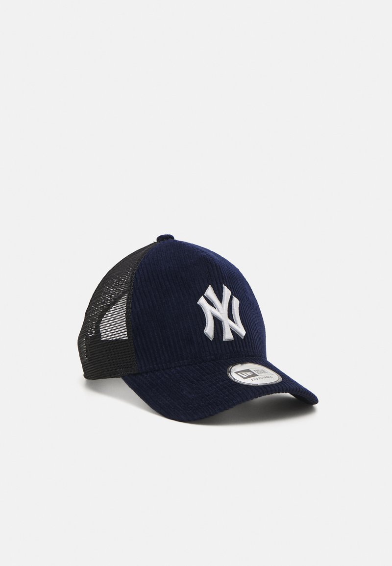 Navy corduroy baseball cap with black mesh sides, featuring a white embroidered logo on the front and a flat visor. Textured fabric details.