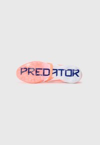 Jalkapallokengät vaaleanpunaisena ja valkoisena, jossa on teksturoitu pitoallas, suuri "PREDATOR" -brändäys ja ainutlaatuinen hihna turvalliseen istuvuuteen.