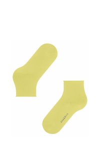 Helle gelbe Knöchelsocken mit einer glatten, dehnbaren Textur und einem abgerundeten Zehendesign. Gedrucktes Logo an der Seite, minimalistischer Stil.