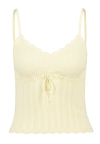 Knit camisole in light yellow with scalloped edges, ribbed texture, and a drawstring detail at the waist. Sleeveless with thin straps.