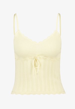 Knit camisole in light yellow with scalloped edges, ribbed texture, and a drawstring detail at the waist. Sleeveless with thin straps.