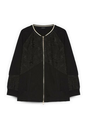 Chaqueta negra con cremallera, bordado floral en el panel delantero y en las mangas, puños acanalados y ribete en contraste en el cuello.