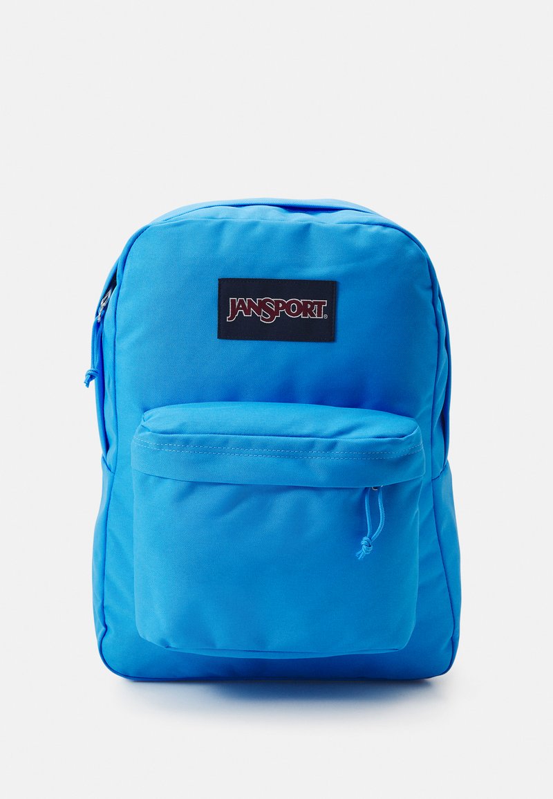 Modrá polyesterová batoh s hlavným vreckom a predným vreckom, oba so zipsami. Logo Jansport na čiernej nášivke. Hladký povrch.