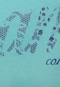 Light blue fabric with textured surface, featuring dark blue animal print patterns and the word "COMFORT" in a bold font.