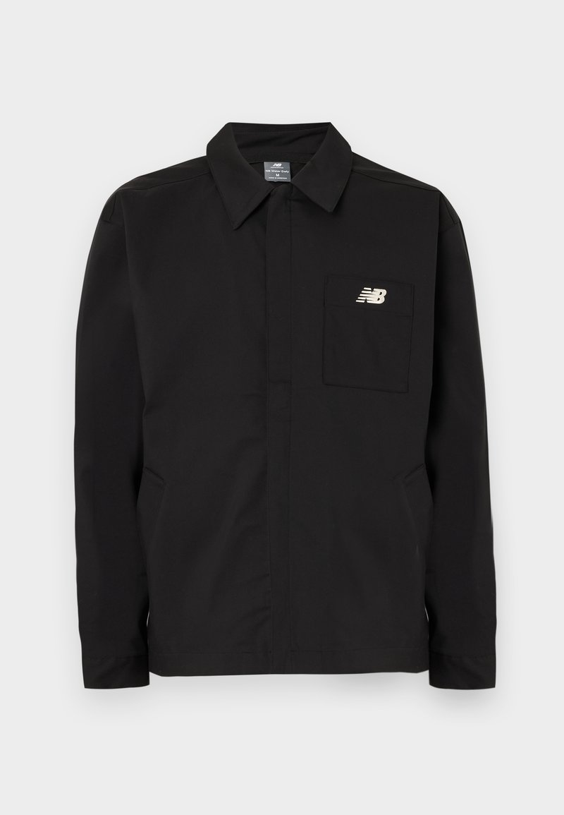 Veste noire en nylon avec un col, dotée d'une poche poitrine et du logo New Balance. Texture lisse et coupe droite.