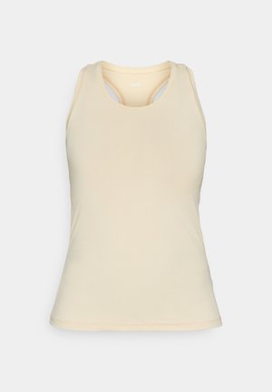 Šviesiai smėlinės spalvos liemenėlė, pagaminta iš glotnaus audinio. Tiene apvalią kaklą, lenktą nugarą ir subtilius siuvimo akcentus.