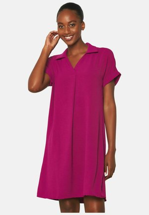 Short-sleeve, V-neck dress in bright magenta, made of soft fabric with a relaxed fit, featuring side slits for ease of movement.