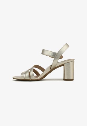 Sandal in metallo dorato con tacco alto, cinturini incrociati, punta aperta e cinturino alla caviglia. Design con tacco a blocco. Texture liscia.