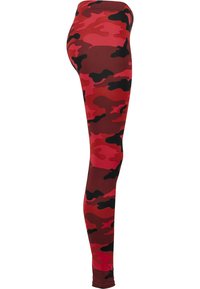 Røde camo leggings med en blanding av mørkerøde, svarte og rosa flekker. Laget av glatt, stretchy stoff med en tettsittende design.