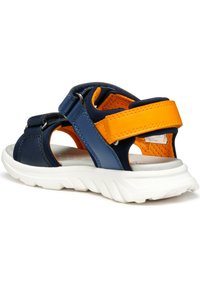 Navy blue and orange sandal with soft fabric straps, white rubber sole, and a textured, lightweight design; features adjustable closures.