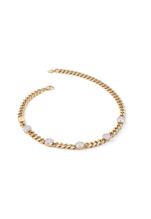 Gold chain necklace featuring large clear gemstones set between links, with a secure clasp and a small decorative triangle accent.