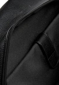 Schwarzes Textilledertaschen Innenfutter mit glattem Innenfutter, Reißverschluss und schwarzem Stoffakzent für sichere Aufbewahrung.