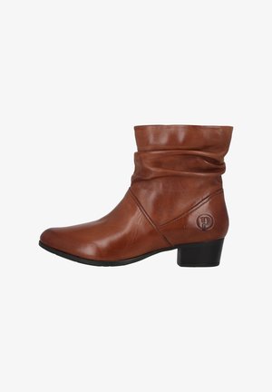 Brown leather ankle boot with slouchy design, pointed toe, low block heel, and embossed logo on the side. Smooth texture, casual style.