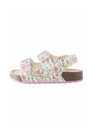 Sandaletter med blomsterprint, to justerbare pink spænder, korkfodbed og pink gummisål. Har en hvid baggrund med farverige blomster.