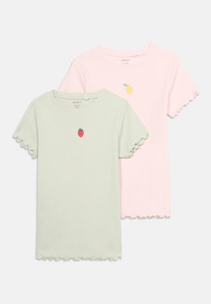 Two ribbed short-sleeve t-shirts with lettuce-edge hems, one light green with a small strawberry embroidery, one pale pink with a lemon embroidery.