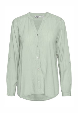 Light green button-up shirt with vertical stripes, slim collar, long sleeves, and roll-tab feature on cuffs. Soft fabric with a relaxed fit.