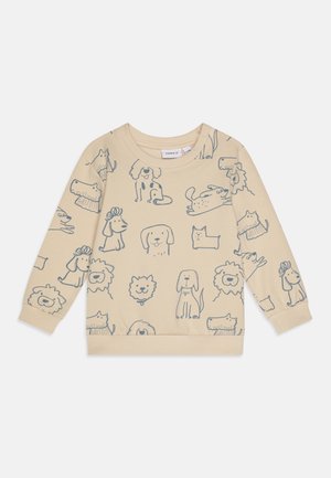 Beige langærmet børnesweatshirt med mønster af håndtegnede blå hunde- og løveansigter, ribmanchetter og rund halsudskæring.