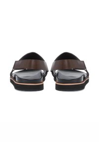 Brown leather sandals with wide straps, a black cushioned footbed, and a contrasting sole. View from the back showing open design.