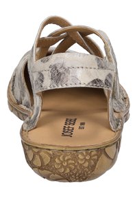 Beige Sandalen mit quer verlaufenden Riemen und floralem Muster, einer strukturierten braunen Sohle mit Blumenmustern und einem glatten Innenbereich.