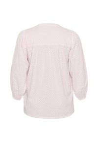 Blusa a pois rosa chiaro, con vestibilità ampia, maniche lunghe a sbuffo e design della parte posteriore arricciato. Tessuto morbido e testurizzato con dettagli sottili.