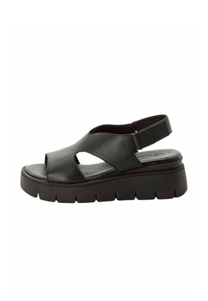 Schwarze Ledersandale mit offenem Zehenbereich und Cut-out-Design, ausgestattet mit einer dicken, strukturierten Plateausohle und einem verstellbaren Riemen am Rücken.