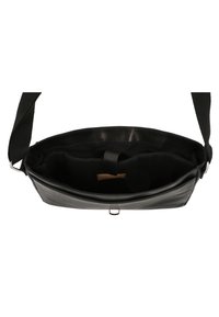Black leather crossbody bag with a smooth texture, interior pockets, and a strap featuring a metal clasp for secure closure.