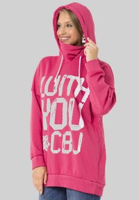 Rosa Kapuzenpullover aus weichem Baumwollstoff, mit großem weißen Grafiktext, einer Kordelzugkapuze und gerippten Bündchen, im Oversized-Schnitt gestaltet.