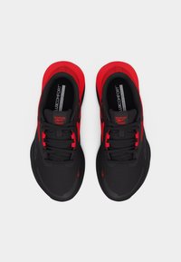 Μαύρα και κόκκινα αθλητικά παπούτσια Reebok με πέλματα LuxComfort, από πάνω σε λευκό φόντο, δεμένα και καθαρά.