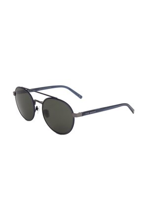 Occhiali da sole ovali neri con montature sottili in metallo e lenti scure, con il marchio Ted Baker sulle aste.