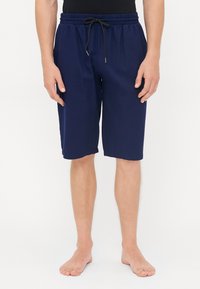 Shorts bleu marine avec une taille élastique, un cordon de serrage et des poches latérales, fabriqués en tissu léger pour le confort.