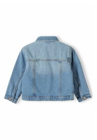 Denimjacka i ljusblått, med klassisk krage, långa ärmar och knappmanschetter. Distinkt bakstycke och två vertikala sömmar.