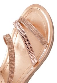 Metallic rose gold sandals with three glittering strap accents, textured footbed, and smooth sole, featuring a glossy finish.