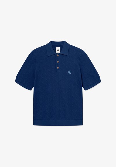 Polo bleu marine en tissu texturé. Présente un motif en losanges, trois boutons marron, et un logo brodé bleu clair.