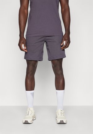 Gray shorts with a casual fit, featuring front pockets and visible stitching, paired with white athletic socks and light-colored sneakers.