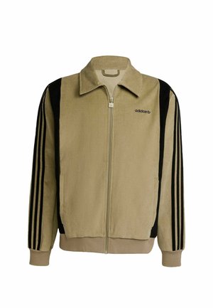 Béžová manšestrová bunda na zip s černými proužky na rukávech, vysokým límcem a vyšívaným logem na levé straně hrudi.