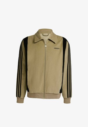 Béžová manšestrová bunda na zip s černými proužky na rukávech, vysokým límcem a vyšívaným logem na levé straně hrudi.