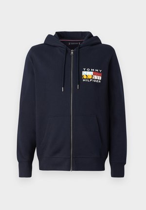 Marinefarbener Zip-Hoodie aus Baumwolle, mit einer Kapuze mit Kordelzug und frontalen Taschen. Zeigt ein mehrfarbiges Logo auf der linken Brust.