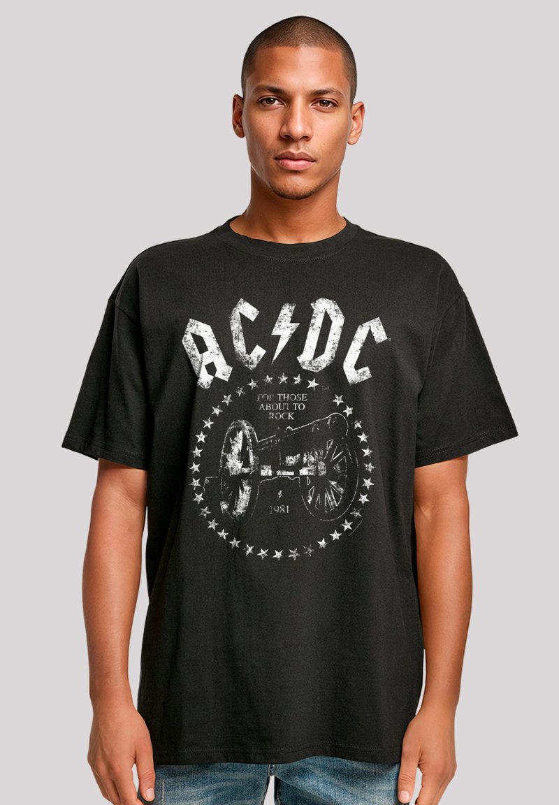 Black cotton t-shirt featuring the AC/DC logo, a cannon graphic, and "For Those About to Rock" text surrounded by white stars.