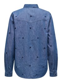 Chemise en denim bleu à manches longues avec petits motifs floraux sombres brodés, empiècement style western et poignets boutonnés, vue de dos.