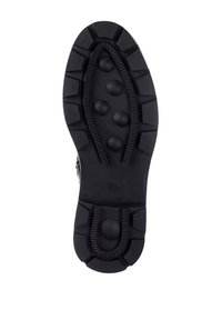 Suola di scarpa in gomma nera con un motivo di battistrada pronunciato. Presenta indentazioni circolari e bordi rigati per migliorare la presa. Superficie texture.