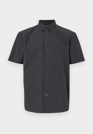 Chemise à manches courtes noire à boutons, fabriquée dans un tissu léger, arborant un motif subtil de petits points blancs et colorés.