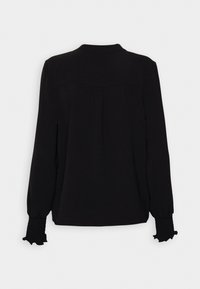 Schwarze Bluse mit langen Ärmeln und hohem Kragen, strukturiertem Stoff, gerafften Manschetten und einer Falten-Detail auf der Rückseite. Glatte Oberfläche, minimalistisches Design.