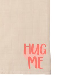Beige textured fabric with a grid pattern, featuring the phrase "HUG ME" in coral within a heart shape at the bottom right corner.