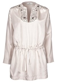 Light beige tunic with long sleeves, a V-neck, cinched waist, and intricate silver embroidery along the neckline. Made of smooth fabric.