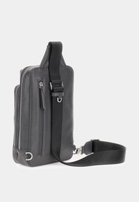 Borsa a tracolla in pelle nera con una finitura testurizzata, dotata di molteplici tasche con zip, una tracolla regolabile e un accento in metallo.