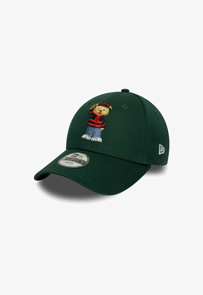 Dark green baseball cap with embroidered bear wearing red jacket, blue jeans, white sneakers, and black hat, tilted to the right.
