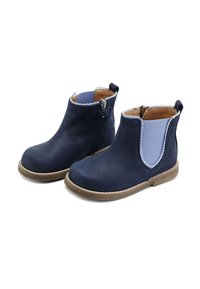 Botines de ante azul marino con laterales elásticos azules, suela marrón y borde festoneado. Cuenta con una cremallera lateral para facilitar su uso.