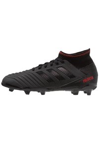 Black Adidas Predator soccer cleat with textured upper, sock-like ankle collar, black laces, and red "PREDATOR" text on heel.