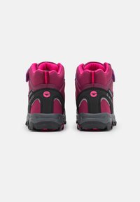 Mid-top hiking boots featuring a black and fuchsia textile upper, rubber soles, and adjustable strap for secure fit. Accents in purple.